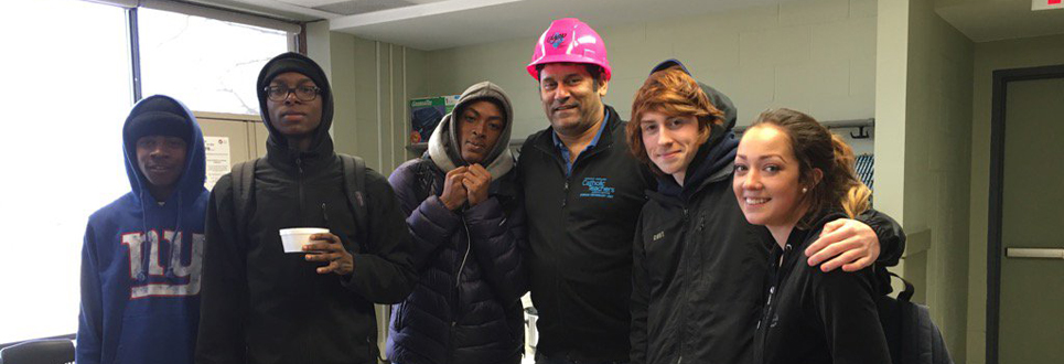 Students with teacher wearing pink OYAP hard hat