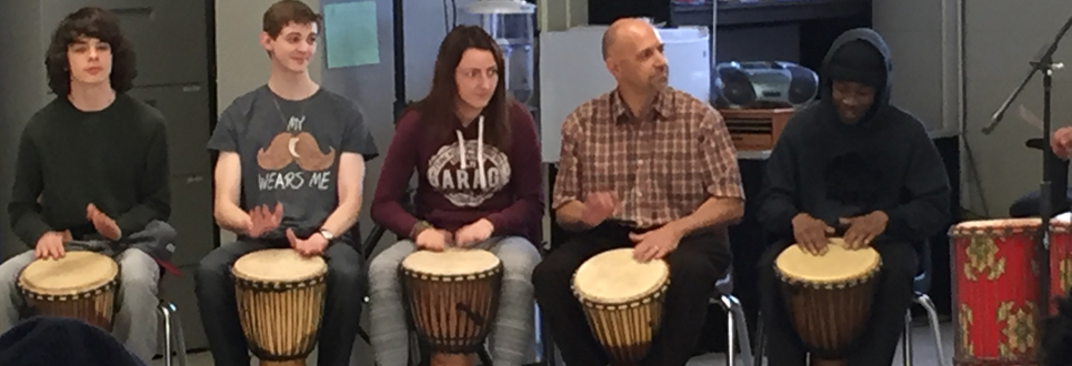 Students playing the drums in a classroom